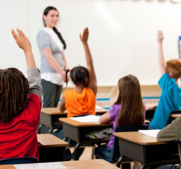 Student raising hands for Teacher