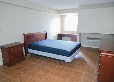 bedroom with desk and dressers