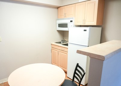 Kitchen with table fridge and microwave