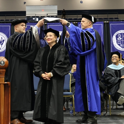 Whitt being hooded at commencement