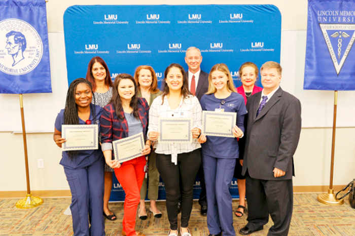 LMU students and administration pose after an awards ceremony in Tampa, Florida.