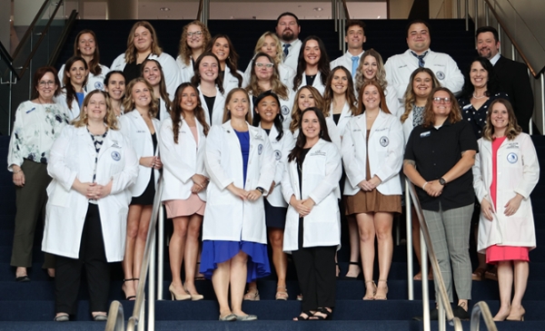 Class of 2027 group photo in white coats