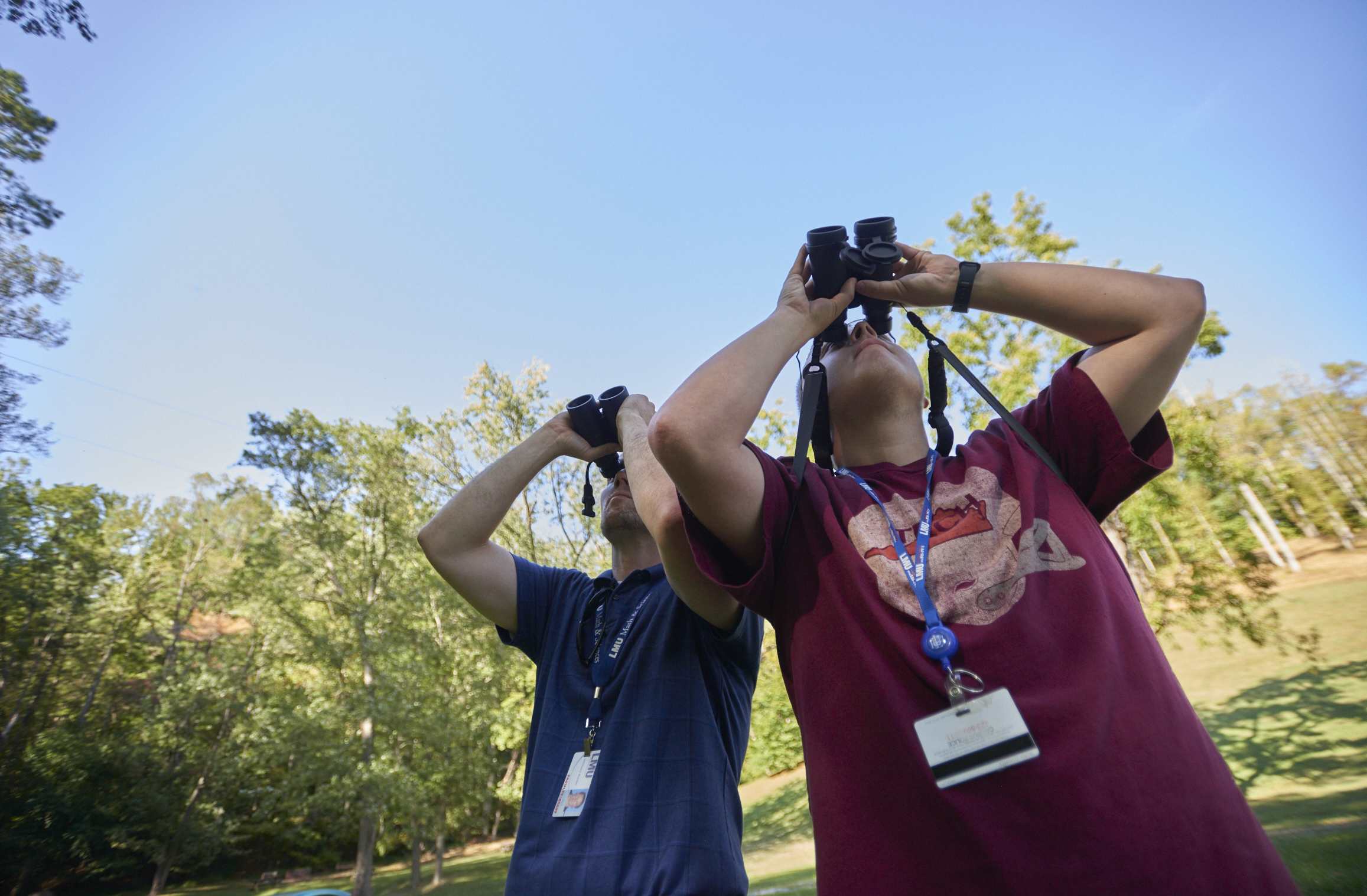 Students outside with binoculars 