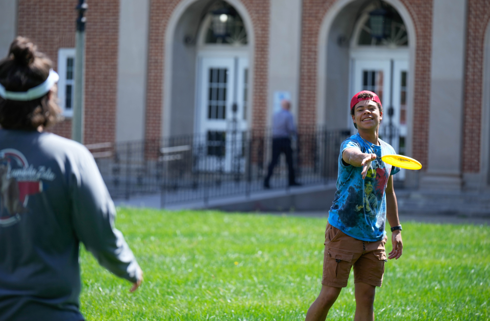 Students playing frisbee.